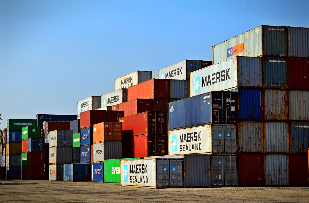 services-03 Colorful stacked shipping containers at a port exemplify global logistics.